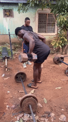 Man performs outdoor dumbbell workout in morning session