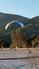 Paraglider lands as beachgoers enjoy sunny day in Fethiye