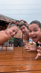 Four people gather around wet table in Ratsada, Thailand