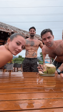 Four people gather around wet table in Ratsada, Thailand