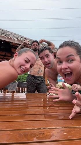 Four people gather around wet table in Ratsada, Thailand