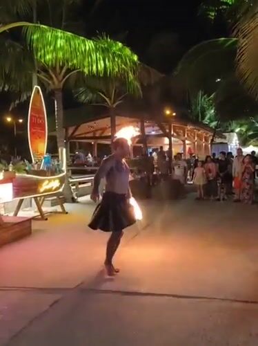 Fire performers light up a Nha Trang beach venue at night