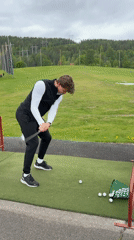 Young man practices golf at Oslo driving range