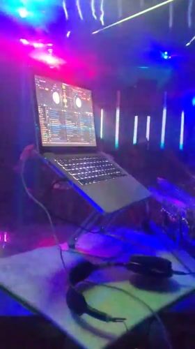 Nightclub event with DJ and colorful lights in Nnewi