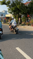 Motorcycles travel residential road in central Vietnam