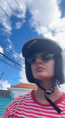 Moped rider spotted in red striped shirt in Kuta Selatan