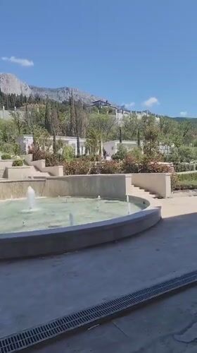 Multi-tiered fountain documented in George park landscaped garden
