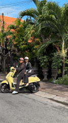Two women ride yellow scooter in North Kuta