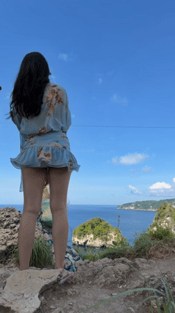 Tourists capture scenic cliff views on Nusa Penida coastline