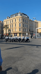 Uniformed group marches in formation in Cannes