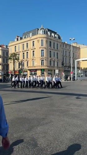 Uniformed group marches in formation in Cannes