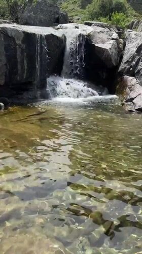 Alpine stream and hillside structure near Hospental, Switzerland