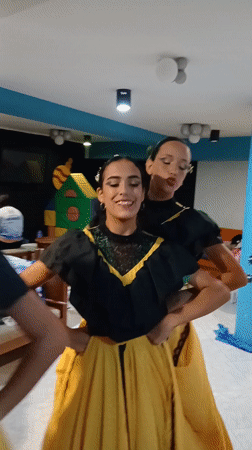 Venezuelan folk dancers rehearse in traditional costumes at Playa El Agua