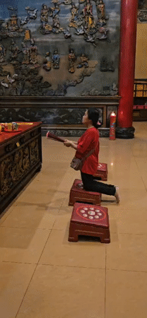 Evening worship observed at illuminated Chinese temple in Denpasar