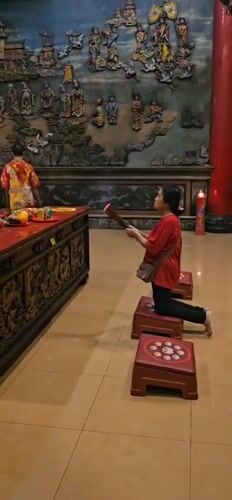 Evening worship observed at illuminated Chinese temple in Denpasar