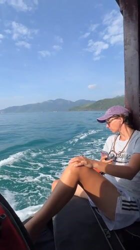 Two women travel by motorboat near Nha Trang coastline