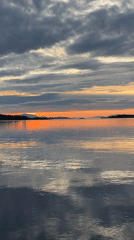 Sunset over calm coastal waters near Harstad, Norway