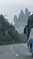 Travelers document misty mountain highway journey through Wulingyuan, China