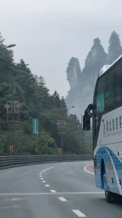 Travelers document misty mountain highway journey through Wulingyuan, China