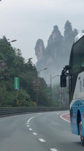 Travelers document misty mountain highway journey through Wulingyuan, China