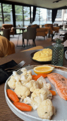 Restaurant meal featuring salmon and vegetables served in Bansko