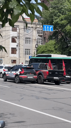 Vehicle convoy with police stops on Yerevan street