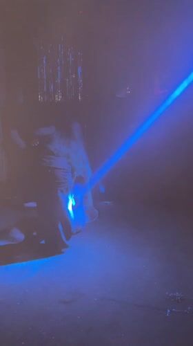 Blue laser lights illuminate smoky room in Almaty