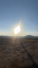 White BMW X5 parked on dusty lot in rural Kazakhstan