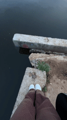 Person contemplates calm waters under cloudy skies in Chaikovsky