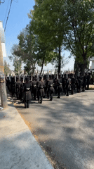 Military parade with uniformed soldiers marches through Puebla, Mexico