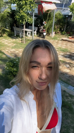 Woman films content in tropical Mũi Né setting