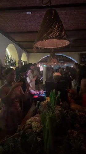 Late-night bar scene with DJs, dancing, and fresh produce in Kuta Selatan