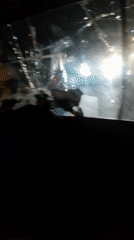 Vehicle travels Nigerian streets with severely cracked windshield at night