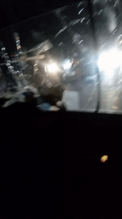 Vehicle travels Nigerian streets with severely cracked windshield at night