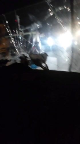 Vehicle travels Nigerian streets with severely cracked windshield at night
