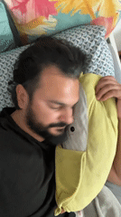 Man sleeps with plush pillow in Mollet Del Vallès