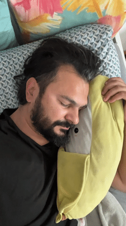 Man sleeps with plush pillow in Mollet Del Vallès
