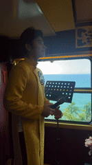 Singer performs in yellow on train car stage in Huế