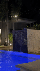 Poolside night at a Rawai resort, drinks and statues included