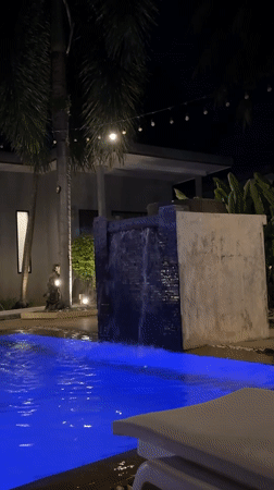 Poolside night at a Rawai resort, drinks and statues included