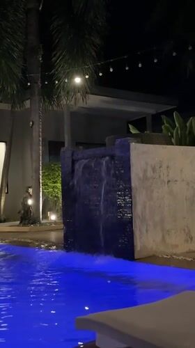 Poolside night at a Rawai resort, drinks and statues included