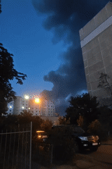 Dark smoke rises over Kyiv residential area at dusk