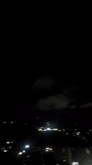 Nighttime aerial views of illuminated Caracas captured from elevated position