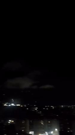 Nighttime aerial views of illuminated Caracas captured from elevated position