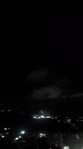 Nighttime aerial views of illuminated Caracas captured from elevated position