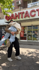 Young couple enjoys playful moments on sunny Sofia street