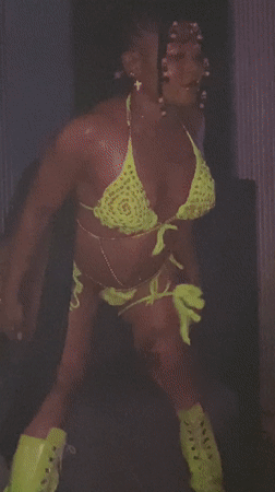 Woman dances in green bikini at Kamazo nightclub venue