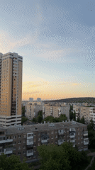 Sunset cityscape captured showing mix of old and new buildings