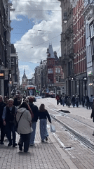 Everyday Amsterdam street life captured during sunny afternoon