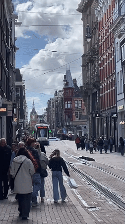 Everyday Amsterdam street life captured during sunny afternoon
